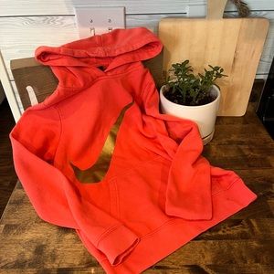 Coral/pink Nike hoodie with gold check girls size medium.